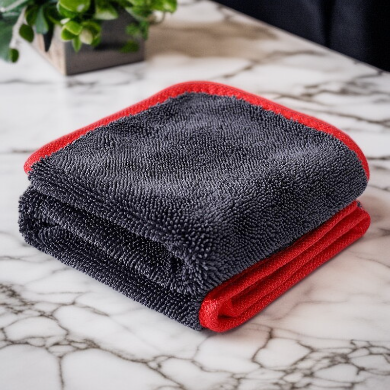 Double sided absorbent edge wrapped cleaning towel
