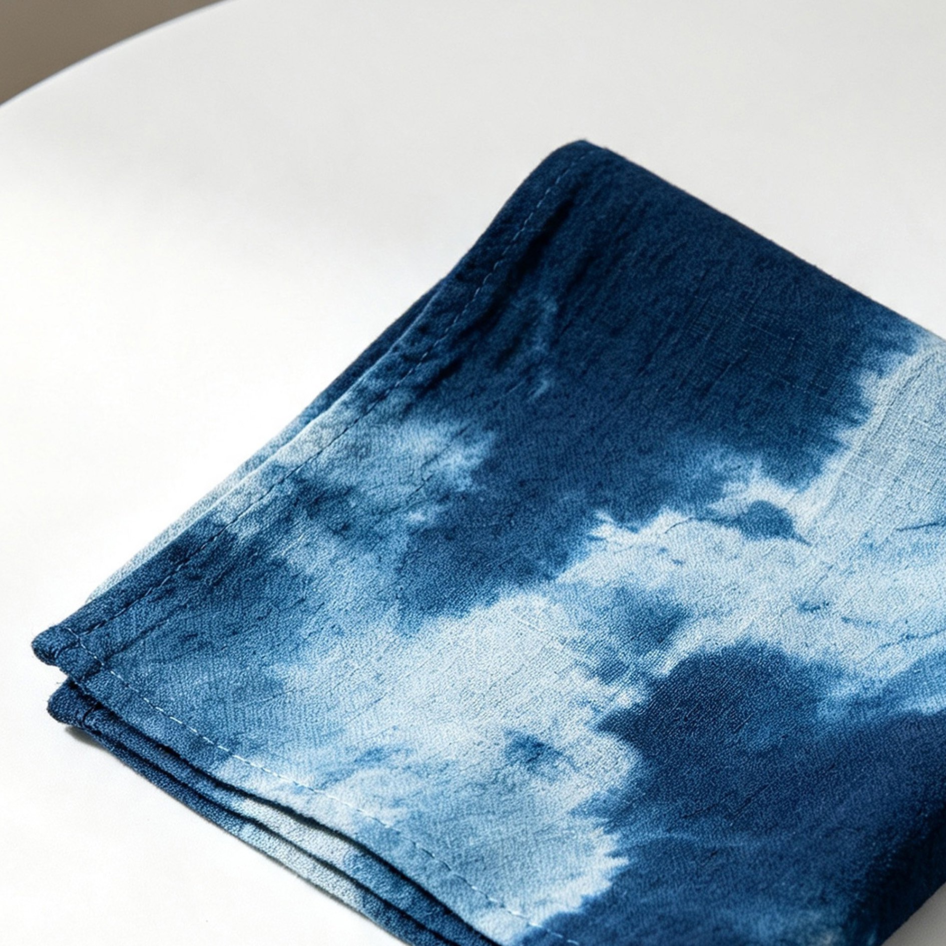 Handmade indigo-dyed cotton and linen tea towel folded on kitchen counter