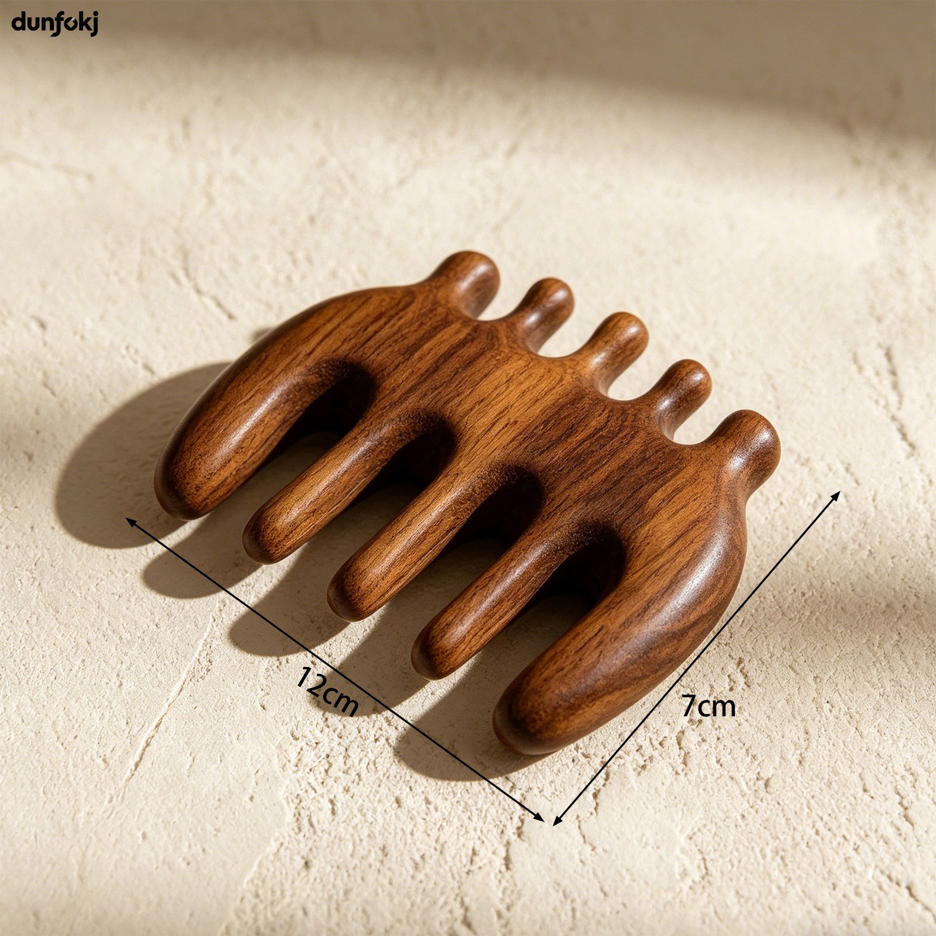 Hand holding a natural wooden hair comb