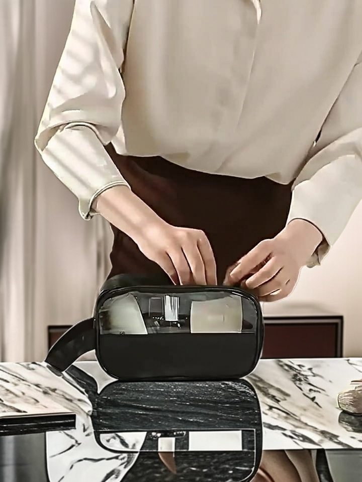 See-through travel toiletry bag packed with personal care items
