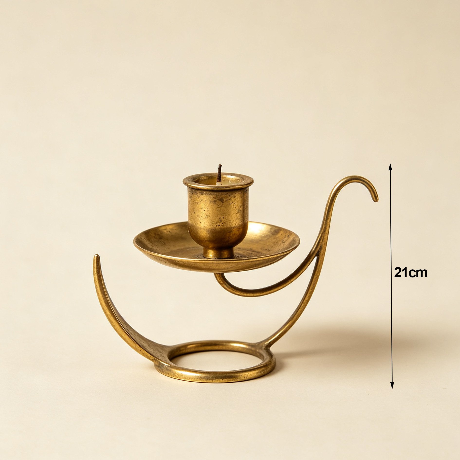 Set of three vintage distressed brass candlesticks on wooden table