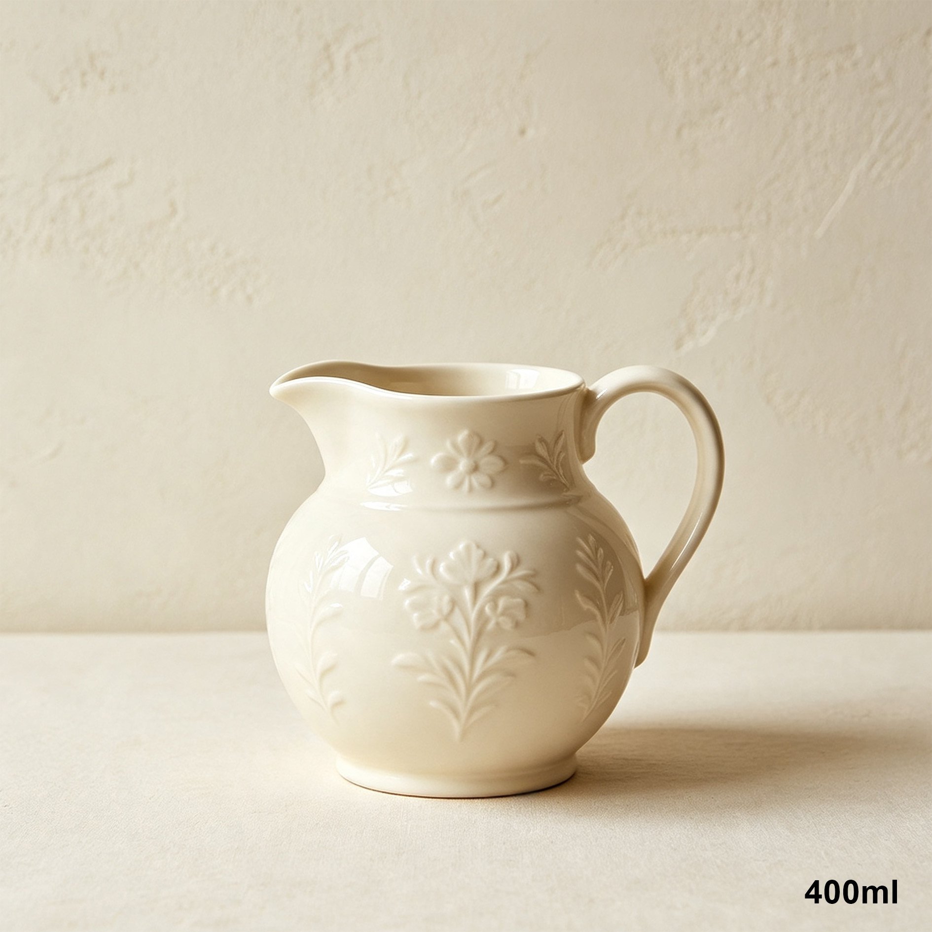 Ceramic milk jug pouring milk into coffee cup