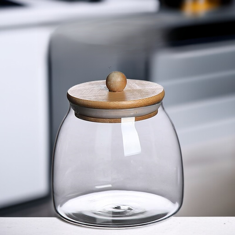 Recipiente para té de vidrio transparente con tapa de bambú y madera.