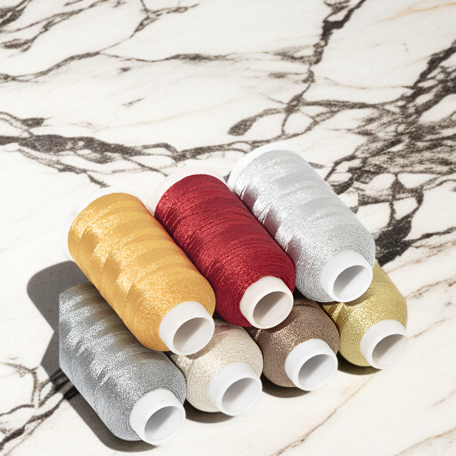 Decorative gold and silver thread spools