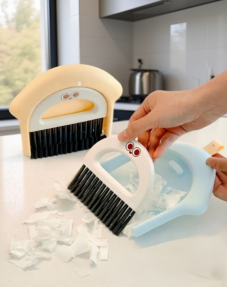Portable keyboard cleaning brush beside a laptop