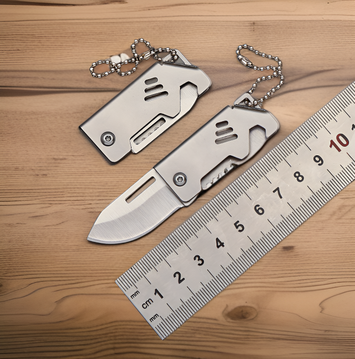 Compact folding knife attached to keychain