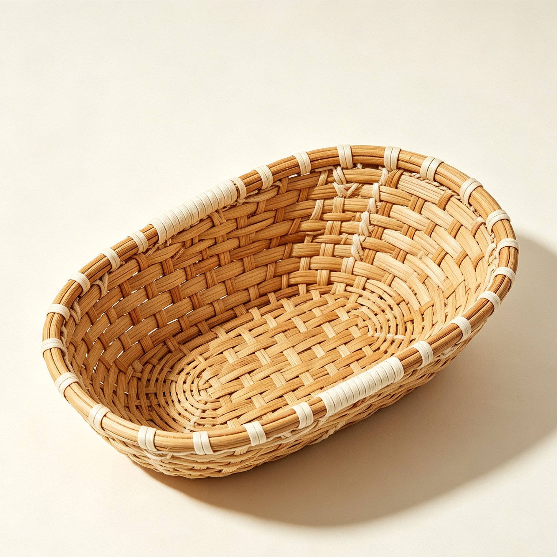Oval woven storage basket made of raw wood on white background