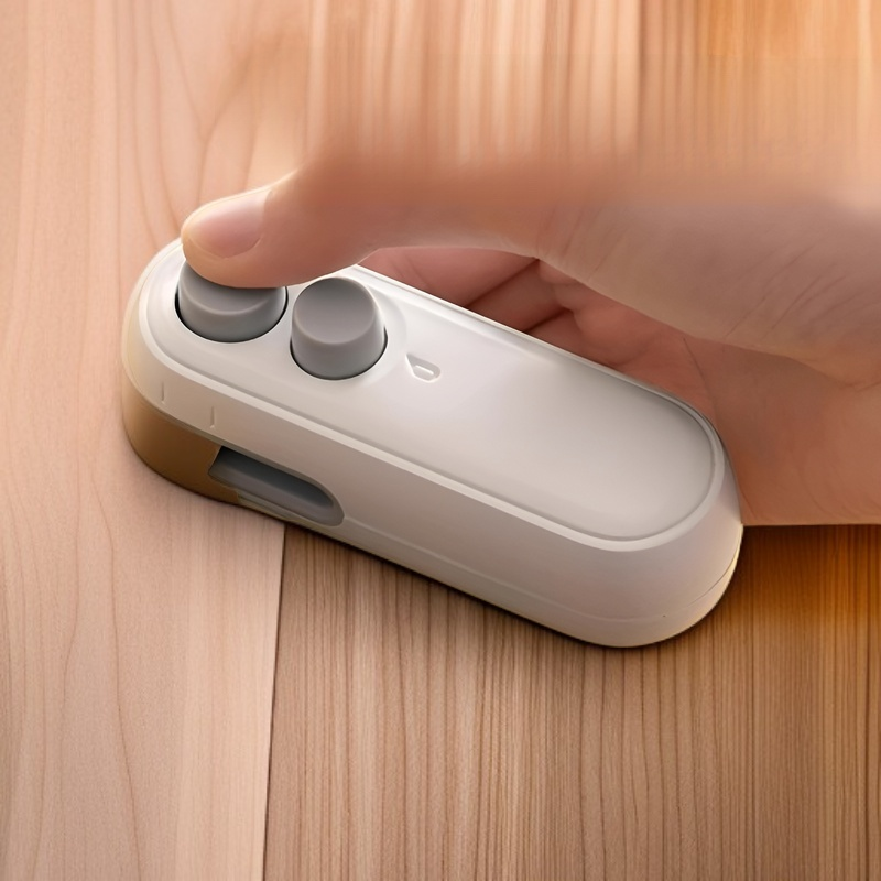 Mini handheld magnetic bag sealer sealing a snack bag