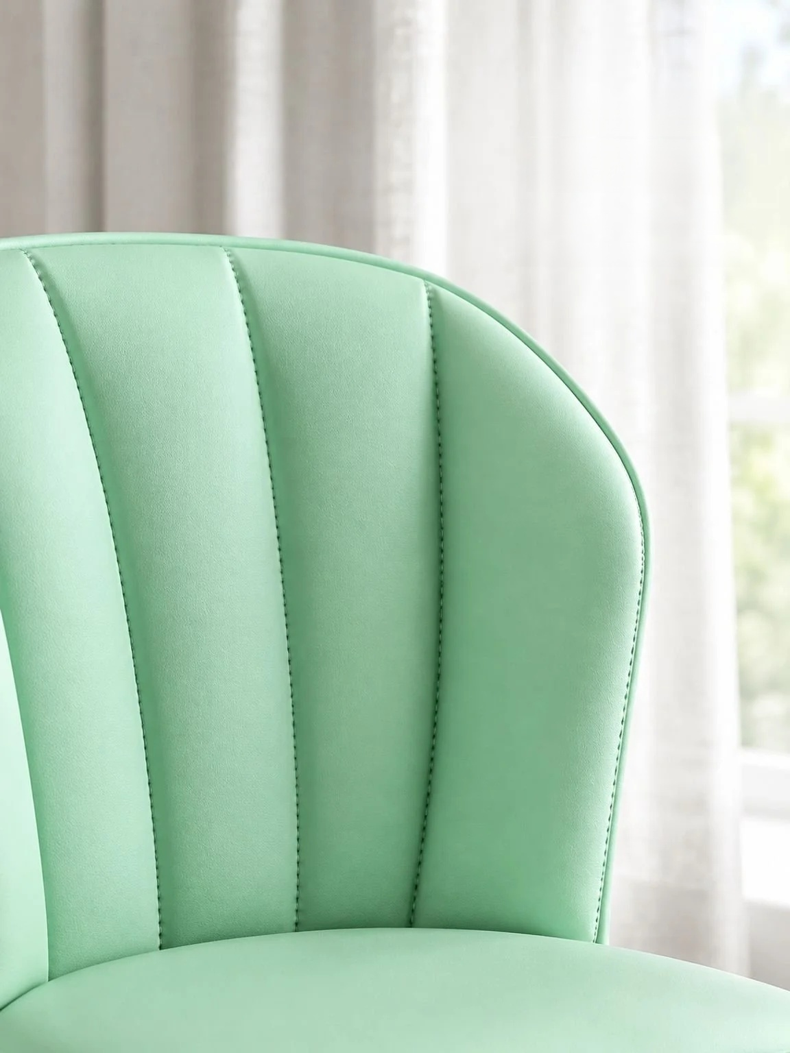 Side view of a minimalist cream dining chair