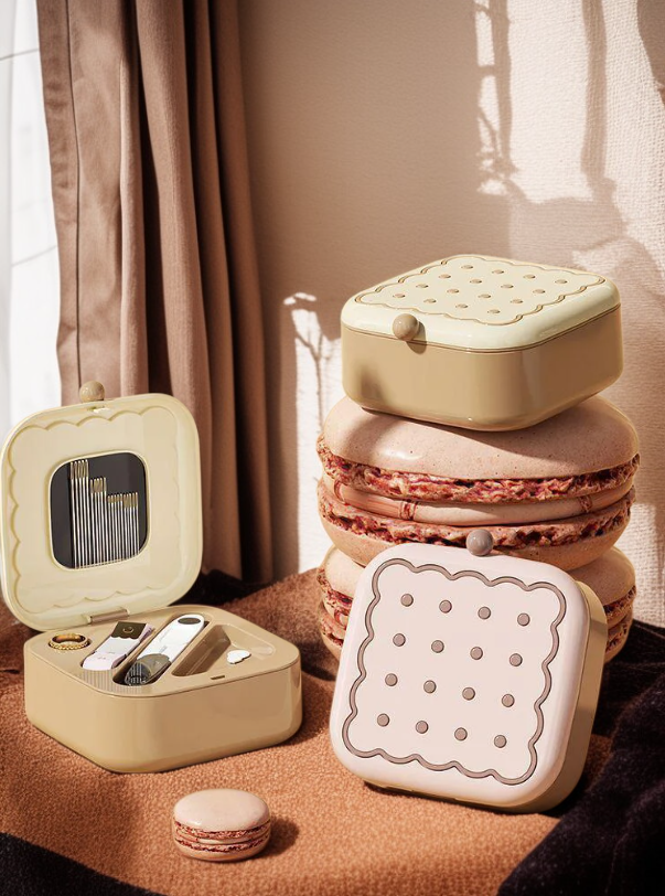 Hand holding the Magnetic Cookie Sewing Box