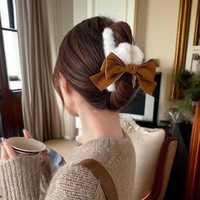 Side view of plush bow hair clip in hair