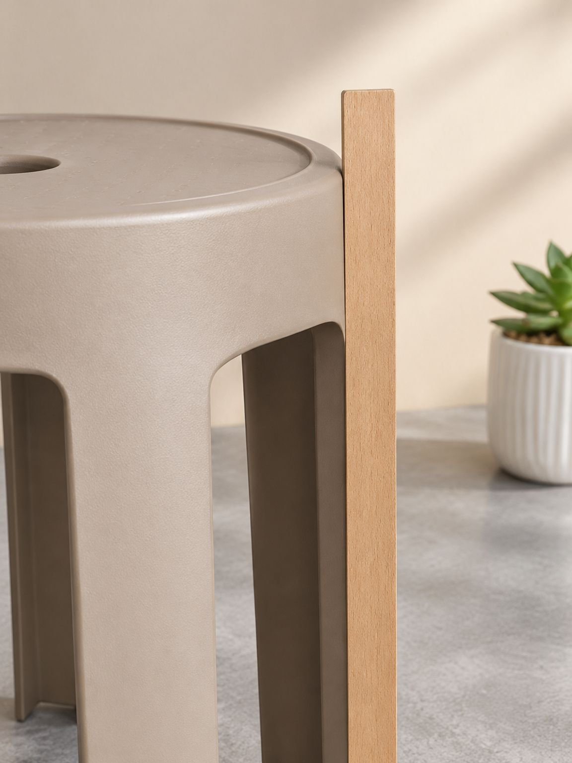 Modern plastic stool serving as a compact bedroom seat