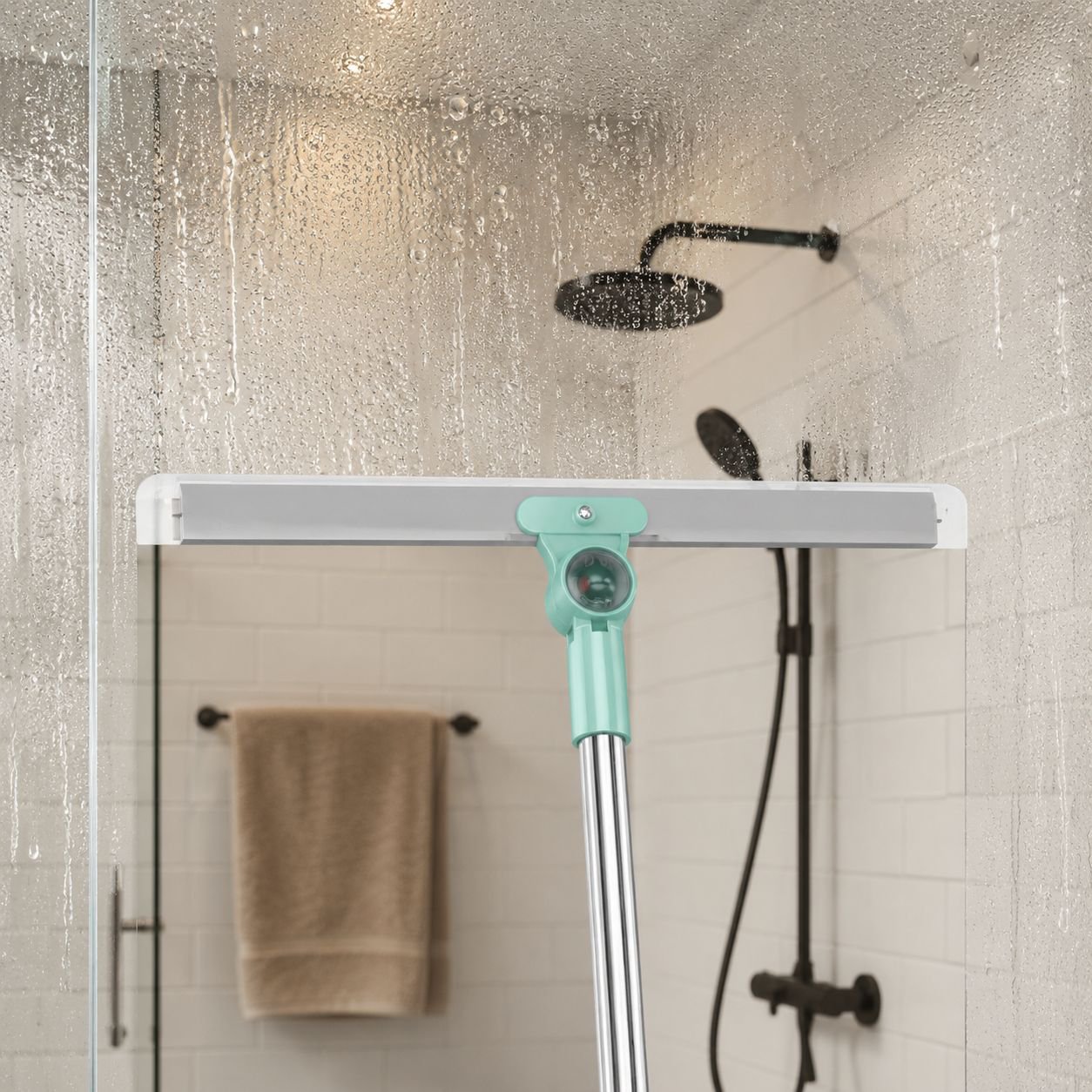 Water scraper broom removing water from shower floor