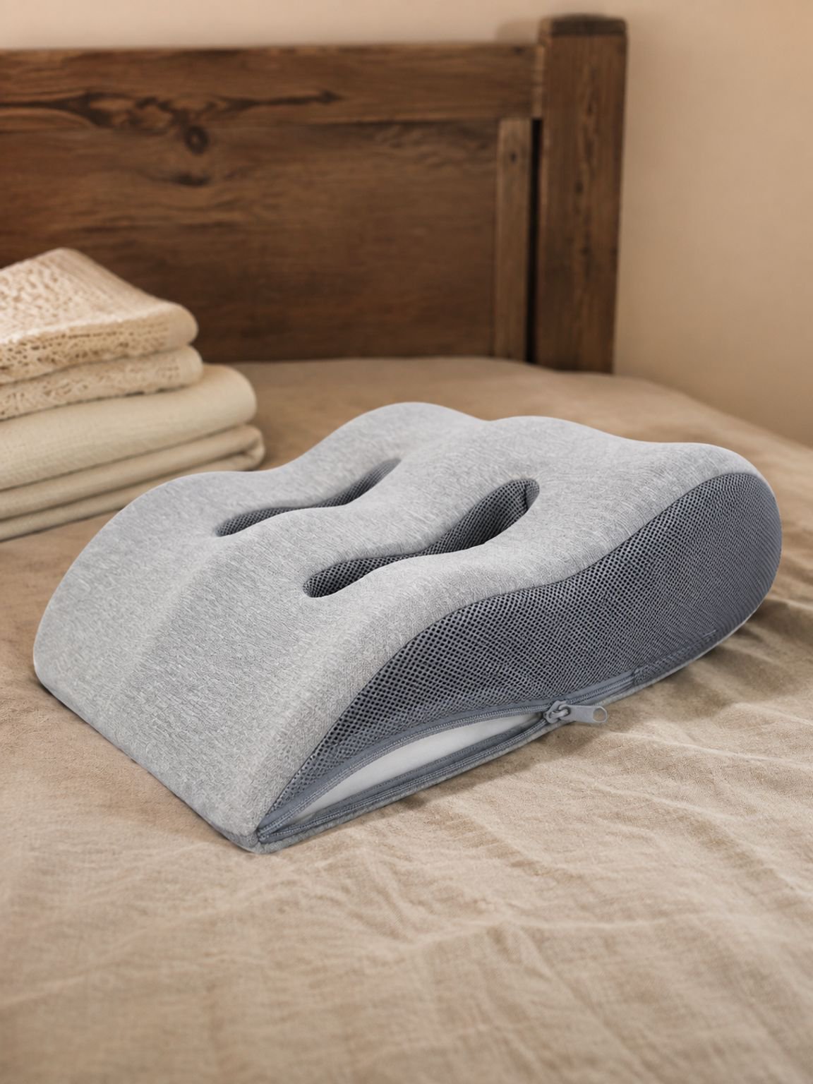 Person resting with legs raised on a supportive elevation pillow