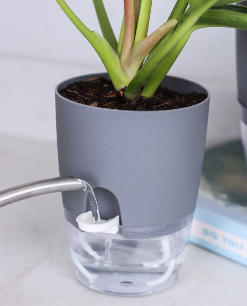 JMY self-watering planter shown with a potted plant